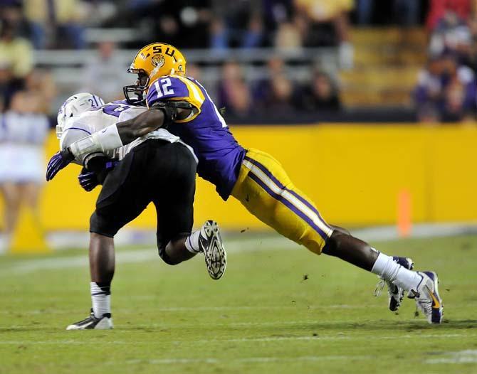 LSU sophomore safety Corey Thompson (12) tackles a Furman defender Saturday, Oct. 26, 2013, during the Tigers' 48-16 win against Furman in Tiger Stadium.