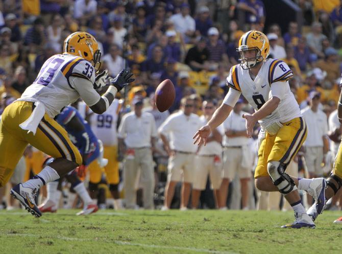 LSU senior quarterback Zach Mettenberger (8) pitches the ball to sophomore running back Jeremy Hill (33) on Saturday, Oct. 12, 2013 during the Tigers' 17-6 victory against the Florida Gators in Tiger Stadium.