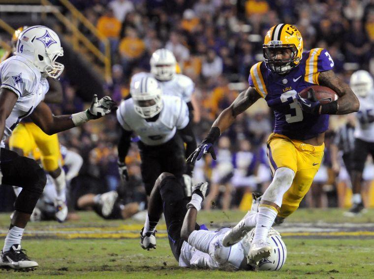 LSU junior wide receiver Odell Beckham Jr. (3) weaves between Furman defenders Saturday night, Oct. 26, 2013 during the Tigers' 48-16 win against Furman in Tiger Stadium.