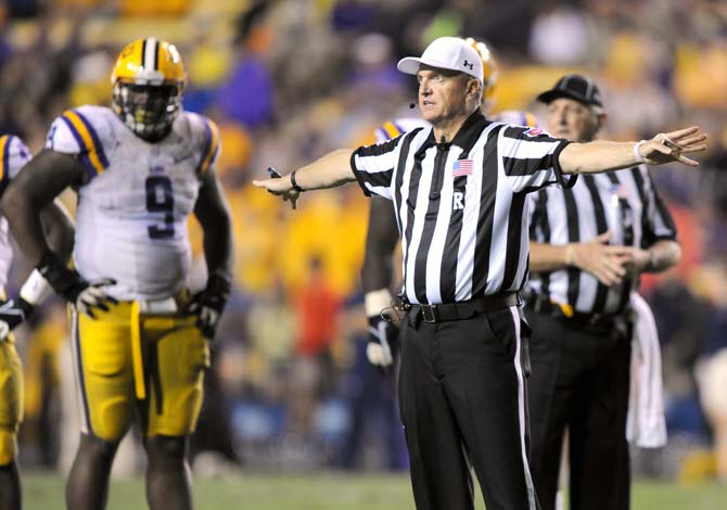 A referee calls a foul Saturday, Sept. 21, 2013 during the Tigers' 35-21 victory against Auburn in Tiger Stadium.