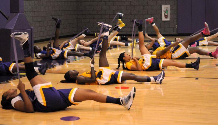 Junior forward Sheila Boykin (left), freshman guard Raigyne Moncreif (middle), junior guard Akilah Bethel (right) and the Lady Tigers warm up for practice Tuesday, Oct. 1, 2013 at the LSU Basketball Practice Facility.