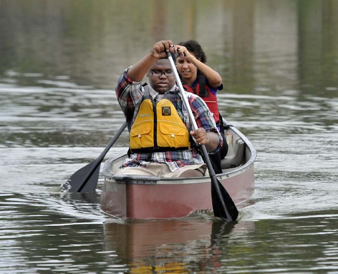 Tremond Parker (front) and Valerie Derouen (back) collectively paddle on the LSU Campus Lakes on Monday, Oct. 21, 2013, at the BREC Milford Wampold Memorial Park on Stanford Ave. They are a part of the LSU EnvironMentors program.