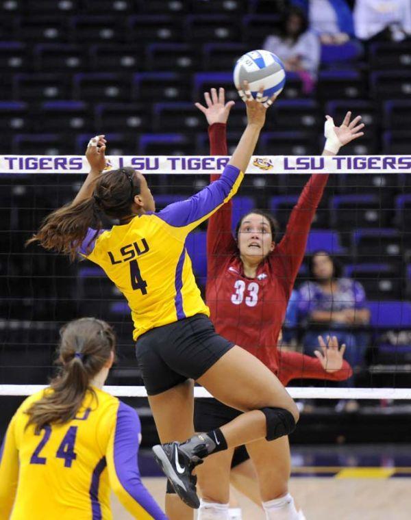 LSU senior middle blocker Desiree Elliott (4) sets the ball Sunday, October 27, 2013 during the Tigers' 3-2 victory against Arkansas at the PMAC.