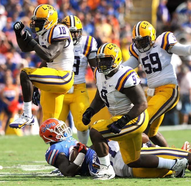 Multiple members of the LSU defense celebrate after a sack Saturday, Oct. 12, 2013 during the Tigers' 17-6 victory against Florida in Tiger Stadium.