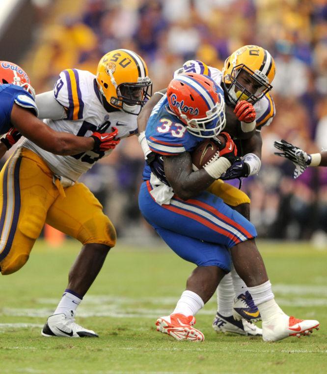 LSU sophomore linebacker Kwon Alexander (25) tackles Florida junior running back Mack Brown (33) during the Tigers' 17-6 victory against the Gators in Tiger Stadium.