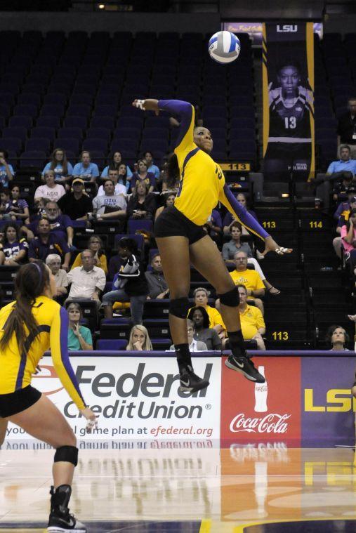 Freshman middle blocker Briana Holman (13) spikes the ball Friday night, Sept. 27. 2013 at the Pete Maravich Assembly Center.