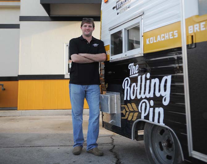 Owner and Operator Will Edwards stands Sunday, Oct. 27, 2013 with their new food truck "The Rolling Pin".