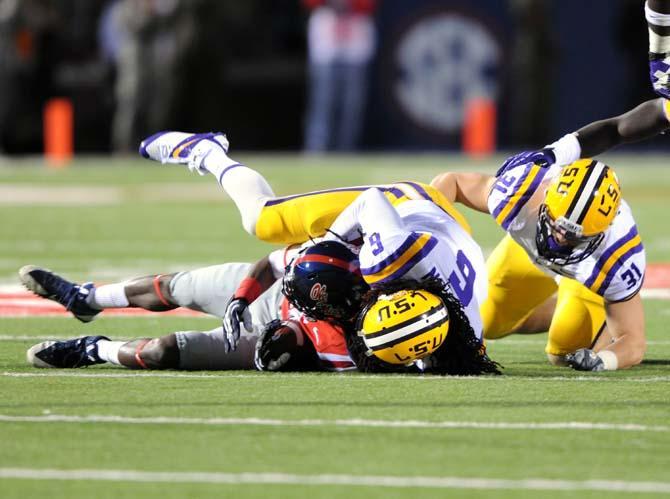 Senior safety Craig Loston (6) tackles an Ole Miss offensive player Saturday, October 19, 2013 during the Tigers' 27-24 loss against Ole Miss at Vaught-Hemingway Stadium.