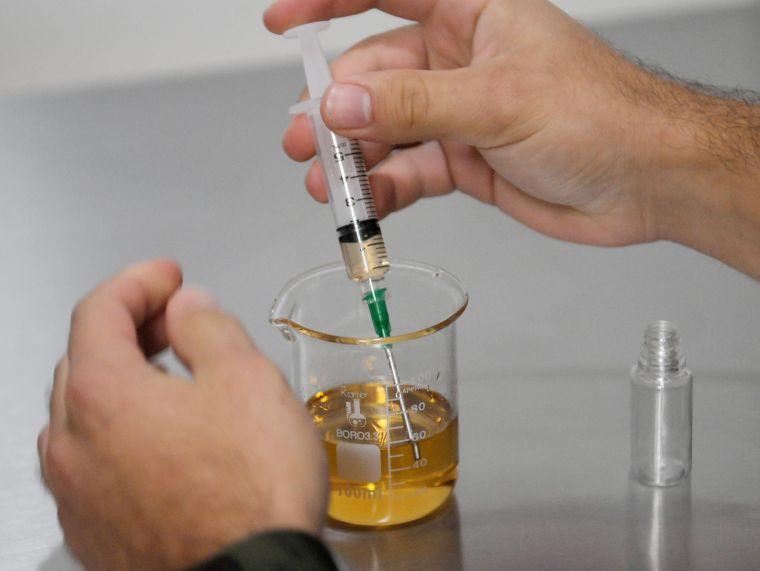 Lucas Bernard, an International Relations senior, measures the nicotine he will use to create a new juice.