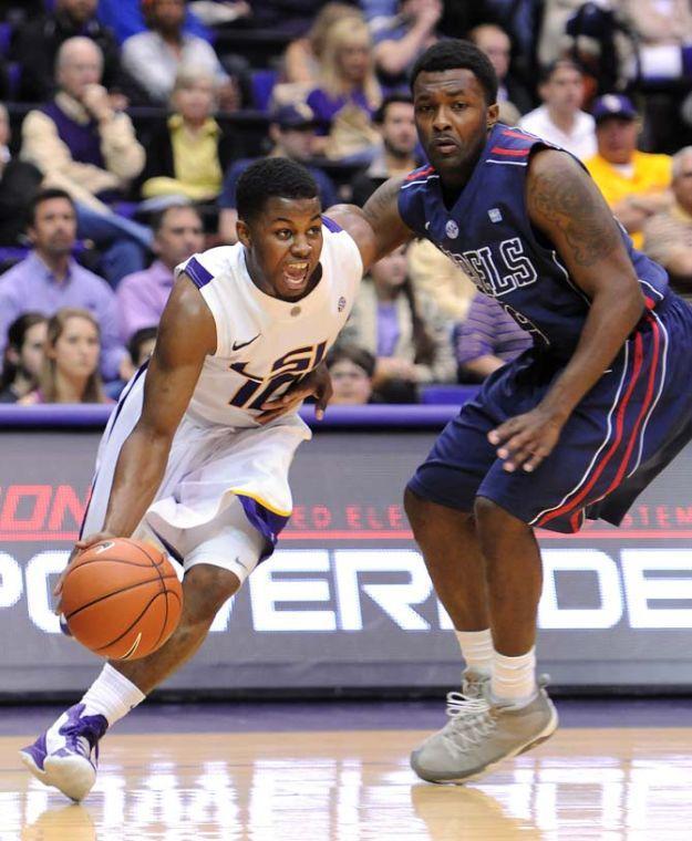 LSU junior guard Andre Stringer (10) drives past Ole Miss senior guard Nick Williams (20) March 9, 2013 during the Tigers' 67-81 loss to the Rebels in the PMAC.