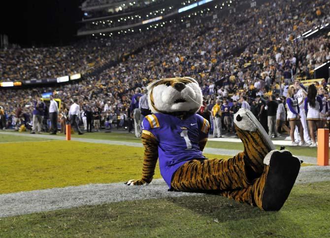 Mike the Tiger lounges on the sidelines Saturday, Oct. 26, 2013, during the Tigers' 48-16 win against Furman in Tiger Stadium.