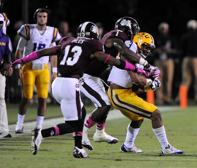 LSU junior wide receiver Odell Beckham Jr. (3) protects the ball while two opposing players try to snatch it on Saturday Oct. 5, 2013 during the 59-26 victory against Mississippi State in Davis Wade Stadium.