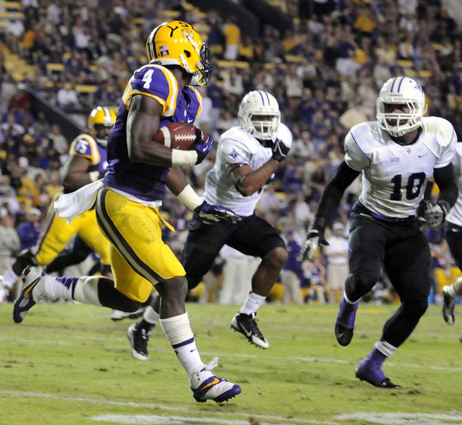 LSU senior running back Alred Blue (4) maneuvers past Furman junior free safety Marcus McMorris (10) on Saturday, Oct. 26, 2013, during the Tigers' 48-16 win against Furman in Tiger Stadium.