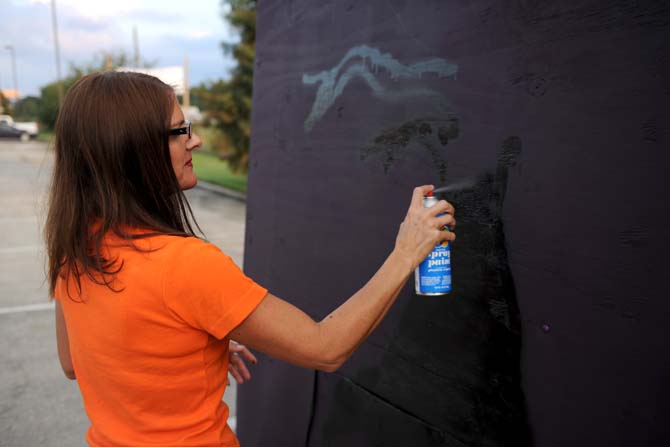 10/31 Consortium board member Deborah Trahan helps set up their float Tuesday, Oct. 15, 2013, for the upcoming 3rd Annual Halloween Parade on Saturday.