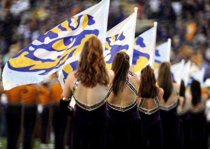 LSU Colorguard members fly the tiger eye flags Saturday, Oct. 26, 2013, during the Tigers' 48-16 win against Furman in Tiger Stadium.