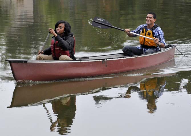 Janay Thomas (left) and De'Marcus Goins, students from Scotlandville Magnet High School, paddle to the shore after an afternoon on the LSU Campus Lakes on Monday, Oct. 21, 2013, at the BREC Milford Wampold Memorial Park on Stanford Ave. They are a part of the LSU EnvironMentors program.