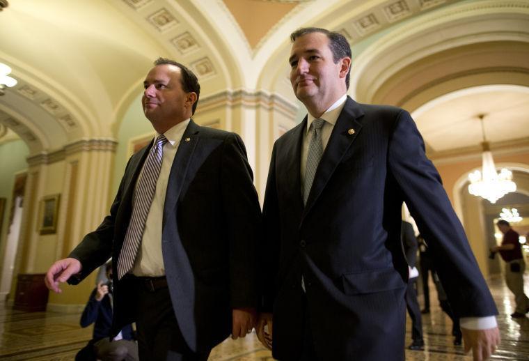 In this Oct. 16, 2013, photo, Sen. Mike Lee, R-Utah, left, and Sen. Ted Cruz, R-Texas, walk to the Senate floor to vote on a bill to raise the debt ceiling and fund the government on Capitol Hill in Washington. The budget-debt brawl has widened the rift between the Grand Old Party and tea party lawmakers who are upset that House Speaker John Boehner and Senate Republican Leader Mitch McConnell agreed to the plan to reopen government without extracting any limits on President Barack Obama's health care law.(AP Photo/ Evan Vucci)