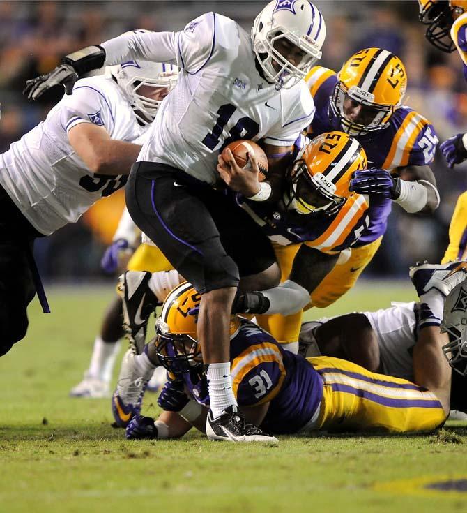 LSU defenders take down a Furman defender Saturday, Oct. 26, 2013, during the Tigers' 48-16 win against Furman in Tiger Stadium.