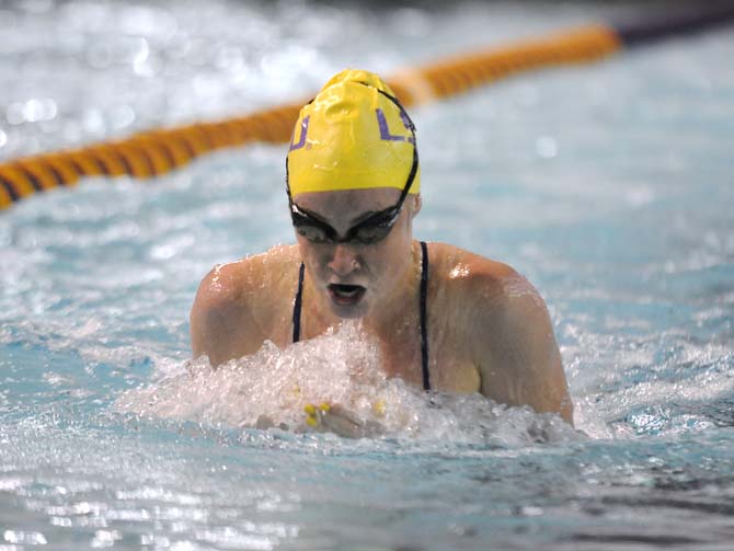 LSU sophomore Taryn MacKenzie takes a breath during the women's 100 yard breaststroke event on Friday October 18, 2013 at the LSU vs. Georgia swim meet in the Natatorium.