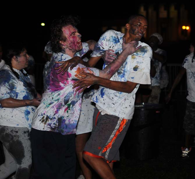 An LSU student attacks a fellow student with paint on Monday, October 21, 2013, during the Splatterbeat homecoming event on the Parade Ground.