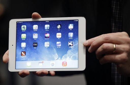 An Apple employee demonstrates the new iPad Mini on Tuesday, Oct. 22, 2013, in San Francisco. Apple unveiled a new, thinner, lighter tablet called the "iPad Air" and the iPad Mini with Retina Display, along with a slew of new Macs Tuesday at an event in San Francisco. (AP Photo/Marcio Jose Sanchez)