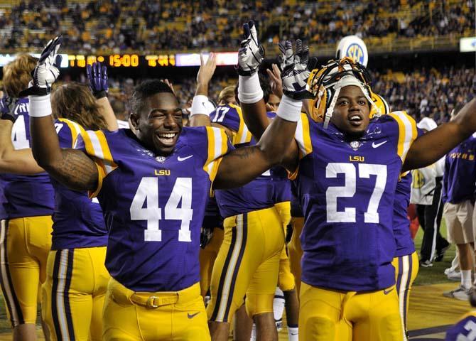 LSU junior defensive back Tre' Sullivan (44) and junior running back Kenny Hilliard (27) pump up the crowd Saturday, Oct. 26, 2013, during the Tigers' 48-16 win against Furman in Tiger Stadium.