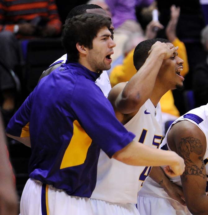 Corban Collins (4), Malik Morgan (24) and Andrew Del Piero (55) cheer on their teammates Saturday, Feb. 23, 2013 during the Tigers' 97-94 tripple overtime victory against the Crimson Tide.