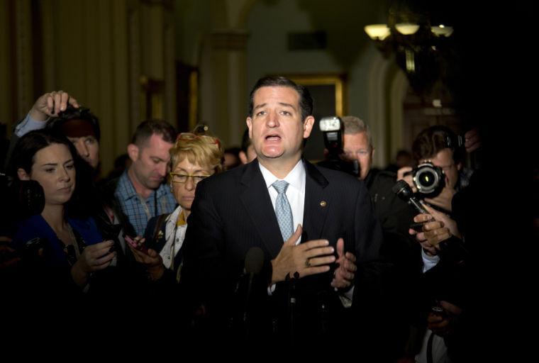 Sen. Ted Cruz, R-Texas, gestures as he talks with reporters on Capitol Hill, Wednesday, Oct. 16, 2013, in Washington. Leaders reached a last-minute agreement to avert a threatened Treasury default and reopen the government after a partial, 16-day shutdown. Cruz said he would not try to block the agreement. (AP Photo/Carolyn Kaster)