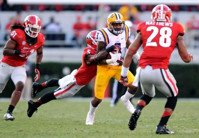 LSU junior wide receiver Odell Beckham Jr. (3) fights off UGA junior cornerback Damian Swann (5) Saturday, Sept 28, 2013 during The Bulldogs' 44-41 victory against the Tigers in Sanford Stadium.