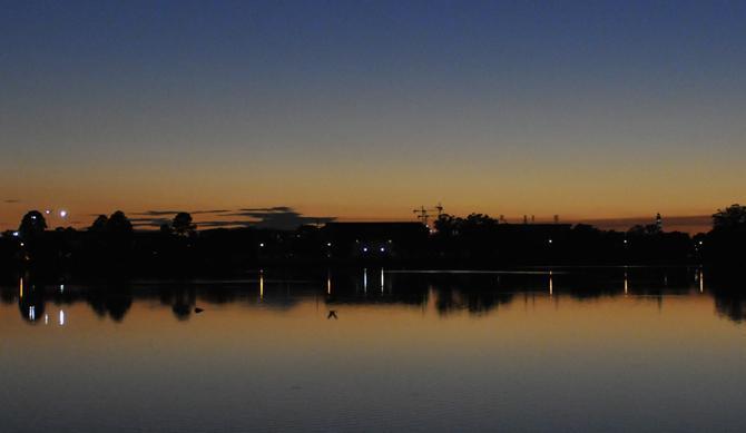 The sun sets behind LSU and University Lake on Sunday, Oct. 20, 2013.