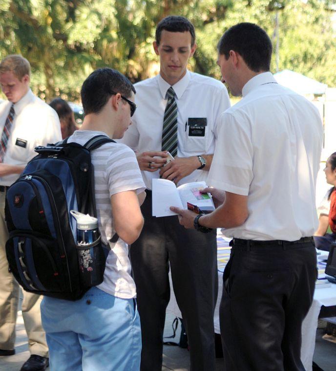 Mormon missionaries Elder Knowlton and Elder Howard speak to Evan Rivere on Wednesday, Oct. 9 in the LSU Free Speech Plaza.