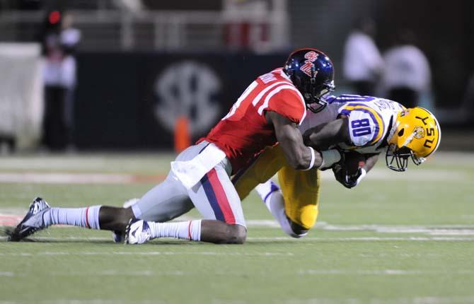 An Ole Miss defensive player tackles LSU junior wide receiver Jarvis Landry (80) on Saturday, October 19, 2013 during the Tigers' 27-24 loss against the Rebels at Vaught-Hemingway Stadium.