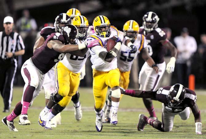 LSU sophomore running back Jeremy Hill (33) runs and avoids being tackled by many players on Saturday October 5, 2013 during the 59-26 victory against Mississippi State in Davis Wade Stadium.