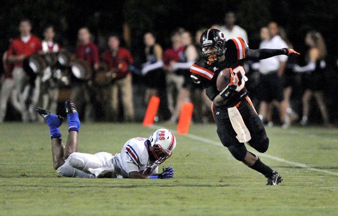 Catholic High School running back Derrius Guice (20) runs past a Parkview Baptist defender Sept. 6, 2013 during the Bear's 28-6 victory against the Eagles at Olympia Stadium.