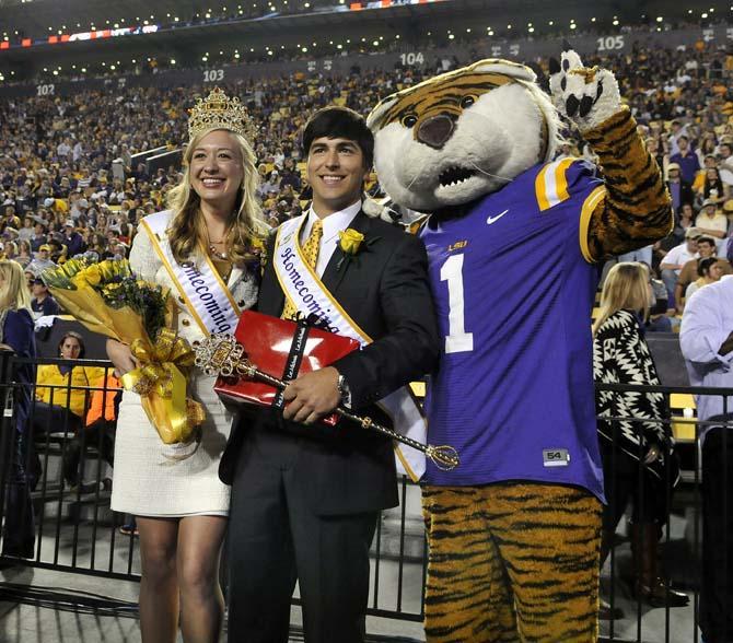 Newly crowned LSU Homecoming queen Emma Arseneaux and king Alex Cagnola pose with Mike the Tiger Saturday, Oct. 26, 2013, during the Tigers' 48-16 win against Furman in Tiger Stadium.