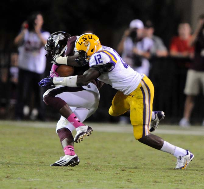 LSU safety Corey Thompson (12) tries to steal the ball on Saturday October 5, 2013 during the 59-26 victory against Mississippi State in Davis Wade Stadium.