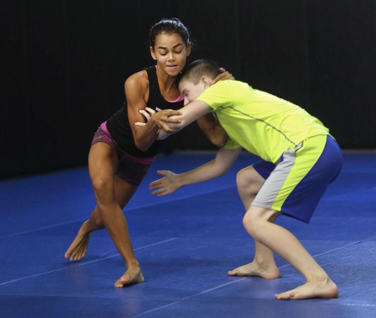 In this photo taken Thursday, Aug. 29, 2013, Lea Bivins, 11, left, and Hunter Bean, 12, work on their wrestling moves during pankration practice in Sacramento, Calif. A bill before the Legislature by Assemblywoman Susan Bonilla, D-Concord, would authorize the California State Athletic Commission to establish regulations for youth pankration competitions. Pankration, which has dramatically grown in popularity in California during the last decade, combines skills from karate and jiu-jitsu. It traces its roots back to ancient Greece where the only rules for the sport styled from boxing and wrestling prevented competitors from biting or gouging each others each others eyes.(AP Photo/Rich Pedroncelli)