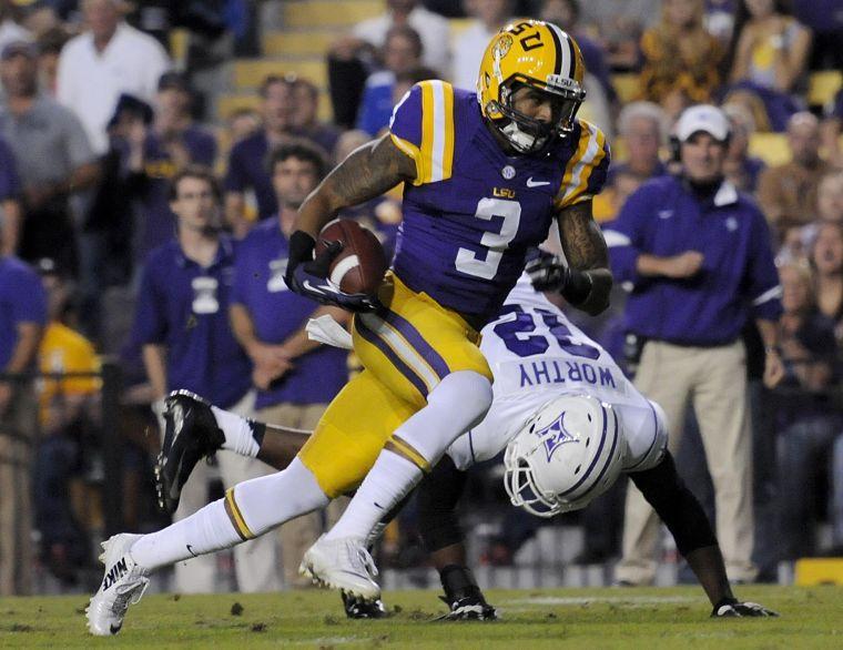 LSU junior wide receiver Odell Beckham Jr. (3) dodges Furman senior strong safety Greg Worthy (32) Saturday night, Oct. 26, 2013 during the Tigers' 48-16 win against Furman in Tiger Stadium.