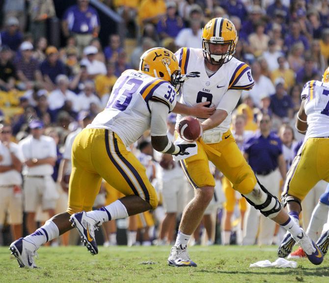 LSU senior quarterback Zach Mettenberger (8) hands off the ball to sophomore running back Jeremy Hill (33) on Saturday, Oct. 12, 2013 during the Tigers' 17-6 victory against the Florida Gators in Tiger Stadium.