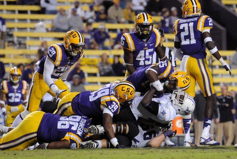 LSU sophomore line backer Kwon Alexander (25) and LSU sophomore defensive back Jerqwinick Sandolph (39) tackle a Furman player Saturday night, Oct. 26, 2013 during the Tigers' 48-16 win against Furman in Tiger Stadium.