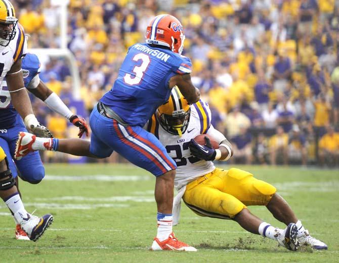 Florida sophomore linebacker Antonio Morrison (3) attempts to bring down LSU sophomore running back Jeremy Hill (33) Saturday, Oct. 12, 2013 during the Tigers' 17-6 victory against the Gators in Tiger Stadium.