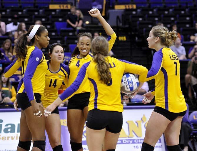 LSU senior middle blocker Desiree Elliott (4) celebrates with her teammates Friday, October 11, 2013 after the Tigers' victory against Ole Miss in the PMAC.