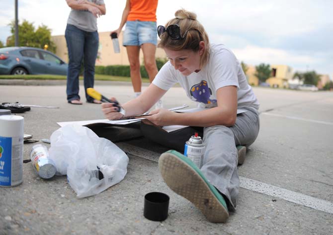 Parade captain and queen, Jessica Edwards, helps set up their float Tuesday, Oct. 15, 2013, for the upcoming 3rd Annual Halloween Parade on Saturday.