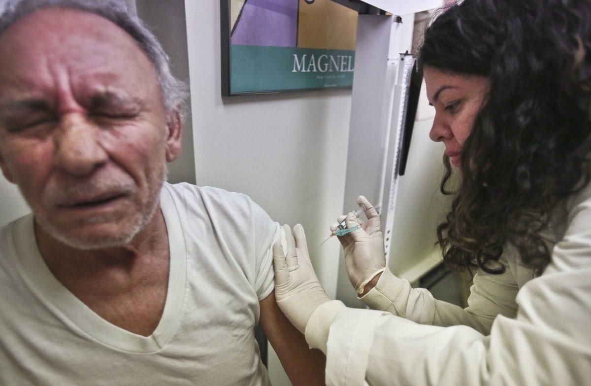 FILE - In this Tuesday, Jan. 15, 2013 file photo, Carlos Maisonet, 73, reacts as Dr. Eva Berrios-Colon, a professor at Touro College of Pharmacy, injects him with flu vaccine during a visit to the faculty practice center at Brooklyn Hospital in New York. Health officials said Thursday, Feb. 21, 2013 this season's flu shot was only 9 percent effective in protecting seniors against the most common and dangerous flu bug. Flu vaccine tends to protect younger people better than older ones and is never 100 percent effective. But experts say the preliminary results are disappointing and highlight the need for a better vaccine. (AP Photo/Bebeto Matthews, File)