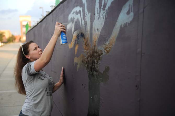 10/31 Consortium Fundraising Chair, Lauren Collins, helps set up their float Tuesday, Oct. 15, 2013, for the upcoming 3rd Annual Halloween Parade on Saturday.