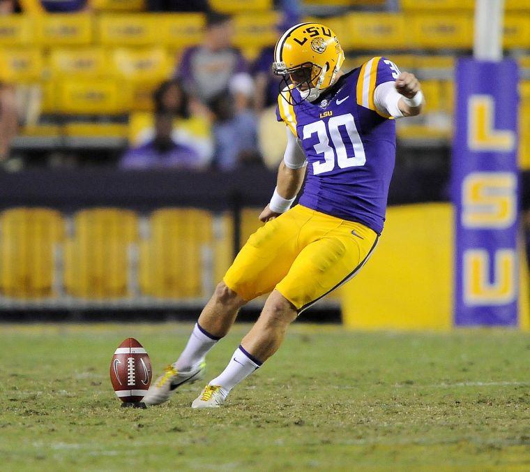 LSU junior place kicker James Hairston (30) kicks the ball downfield Saturday night, Oct. 26, 2013 during the Tigers' 48-16 win against Furman in Tiger Stadium.