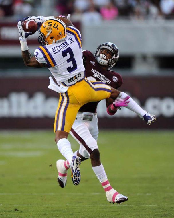 LSU junior wide receiver Odell Beckham Jr. (3) catches a pass while an opposing player tries to tackle him on Saturday Oct. 5, 2013 during the 59-26 victory against Mississippi State in Davis Wade Stadium.