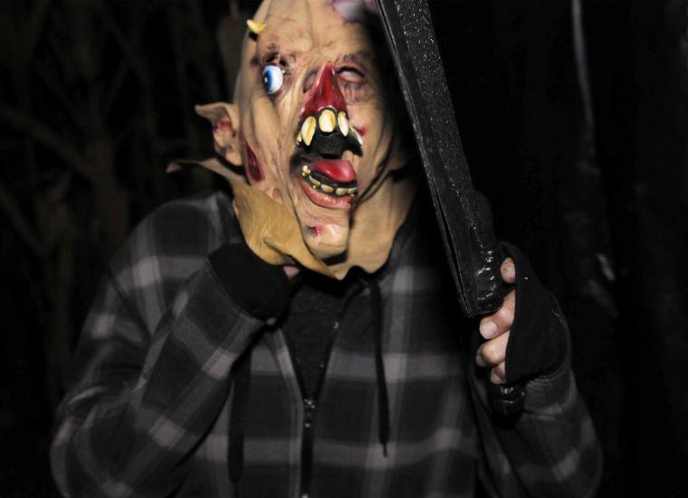 A masked man leaps from the corn Friday night, Oct. 18, 2013 at the Cajun Country Cornmaze in Pine Grove, Louisiana.