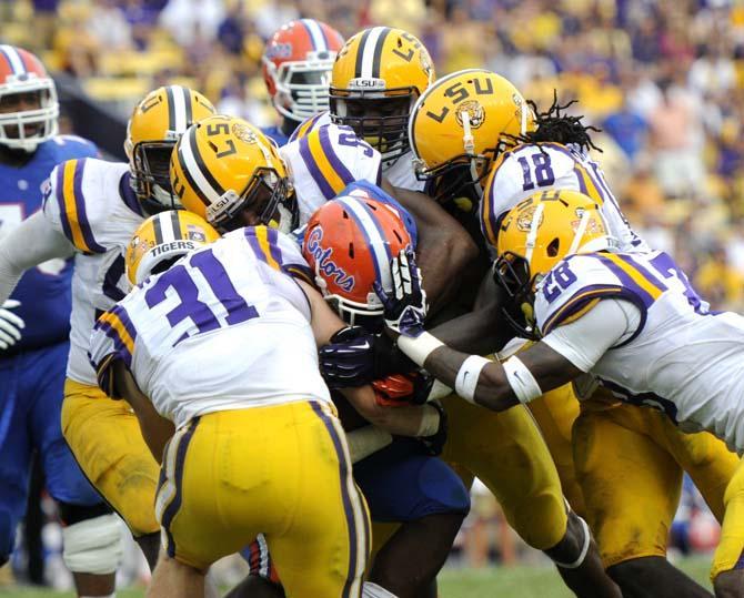 Multiple members of the LSU defensive line attempt to bring down Florida junior running back Mack Brown Saturday, Oct. 12, 2013 during the Tigers' 17-6 victory against the Gators in Tiger Stadium.