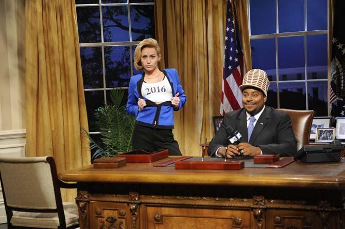 This Oct. 5, 2013 photo released by NBC shows guest host Miley Cyrus, left, and Kenan Thompson in a scene from the late-night comedy series "Saturday Night Live," in New York. (AP Photo/NBC, Dana Edelson)